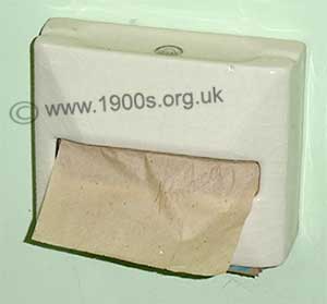 Harsh sheets of toilet paper/lavaory paper in its wall container