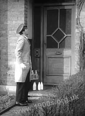 Milkman delivering milk in milk bottles 1940s-1950s England.