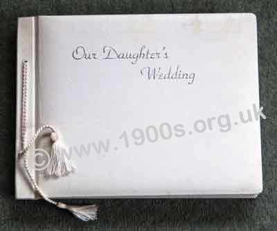 Wedding photo album, professionally produced, mid 20th century: bound in white leather cover embossed in silver with 'Our Daughter's Wedding