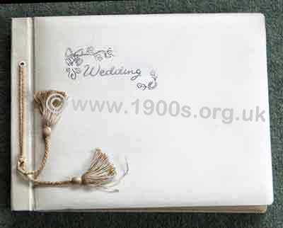 Wedding photo album, professionally produced, mid 20th century: bound in white leather cover embossed in silver with 'Wedding'