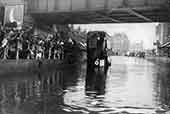 Flooding under a bridge c1920