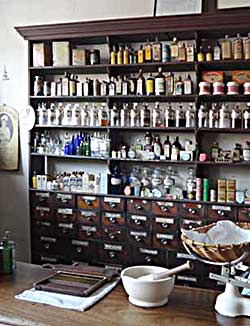 Bottles and storage drawers in a Victorian or Edwardian chemists' shop 