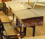 Classroom desks, common in Victorian times to the 1960s, with plank-style wooden seats attached