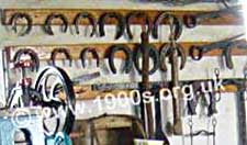 Prepared horseshoes hanging on a smithy's wall