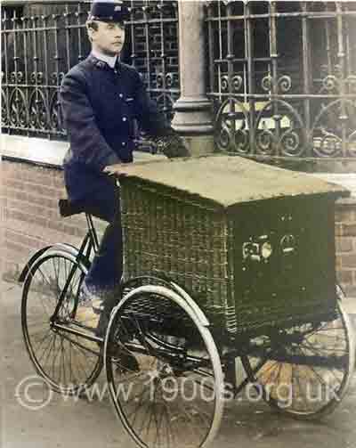 Postman delivering letters by bicycle in the early 1900s UK