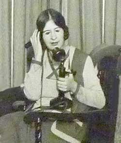 woman using a candlestick phone