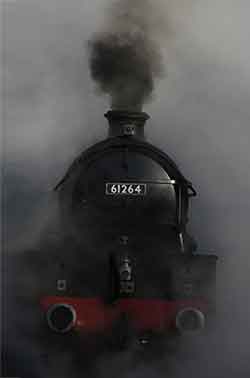 cloud of sooty smoke from the engine of a steam train