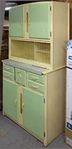 side view of a 1950s kitchen cabinet clearly showing the style of the lower cupboards and drawers being deeper than the top ones and the slide-out pastry board